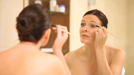 hermosa mujer aplicando maquillaje para los ojos
