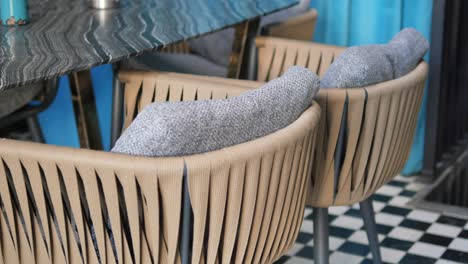 closeup of two chairs at a table with a black and white checkered floor