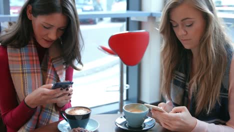 Pretty-friends-enjoying-coffee-in-cafe