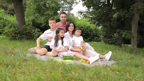 happy family enjoying a picnic in a park