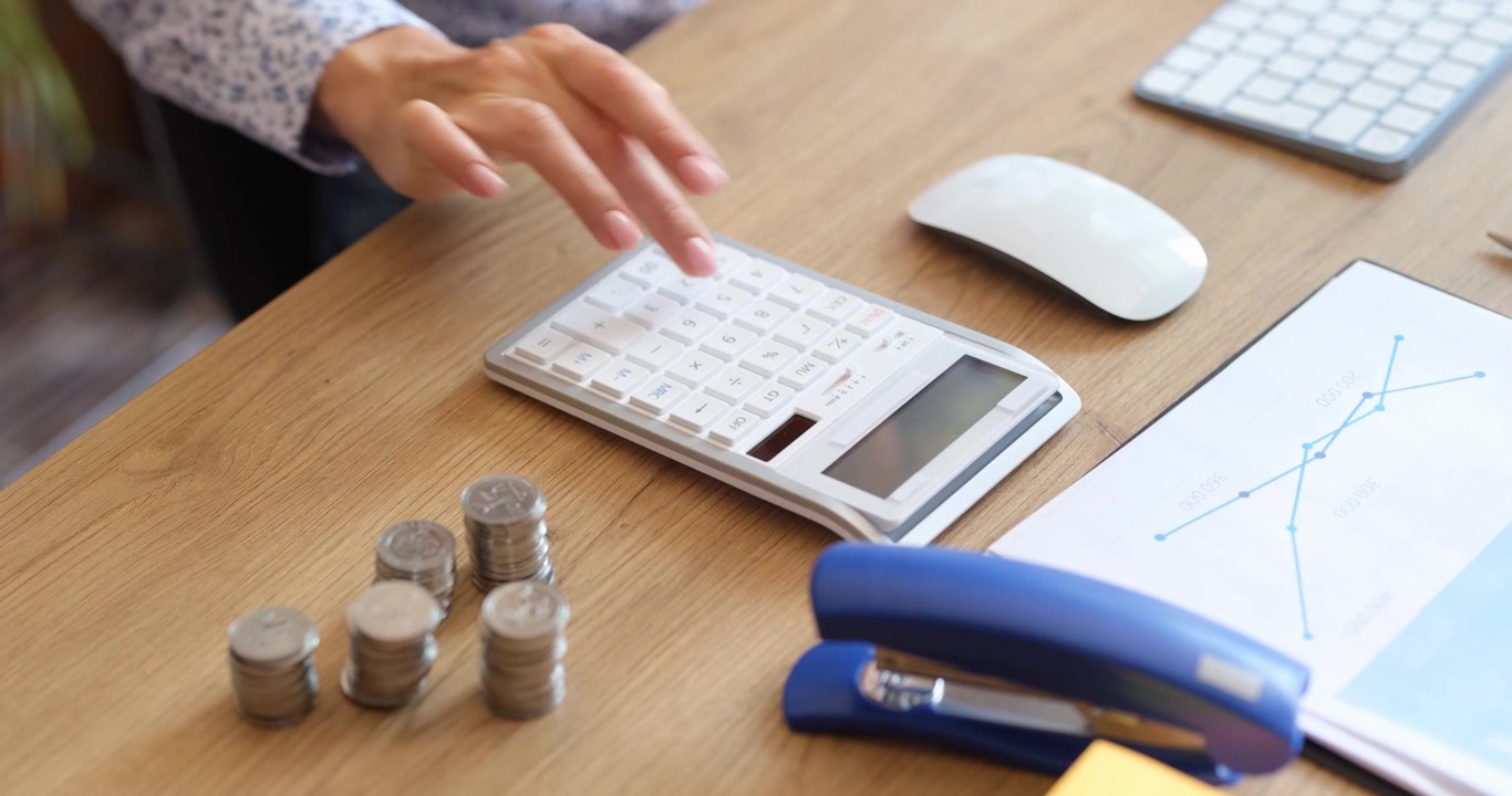 An office workspace featuring a calculator coins and various stationery equipment items