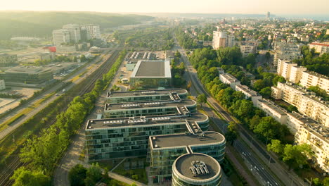 aerial backwards shot of ppnt building and gdynia cityscape in background during sunset