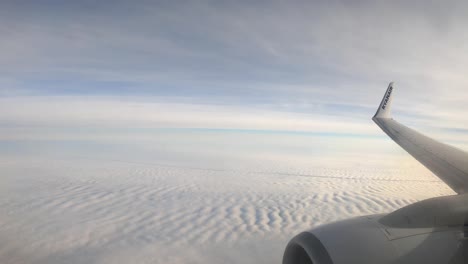 Vista-Impresionante-Del-Cielo-Nublado-Detrás-De-La-Ventana-Del-Avión-Durante-El-Vuelo