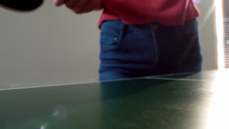 woman playing table tennis at home