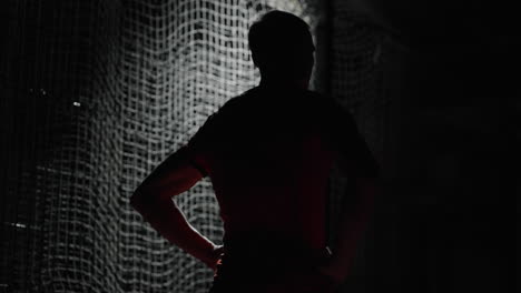 silhouette of an athlete practicing indoors