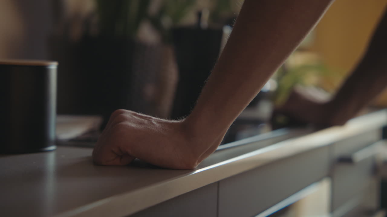 Person's hands on a kitchen counter