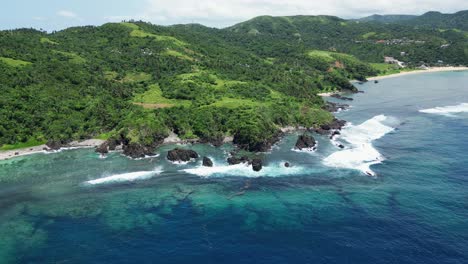 turquoise seascape and green hills in baras, catanduanes, philippines - aerial drone shot