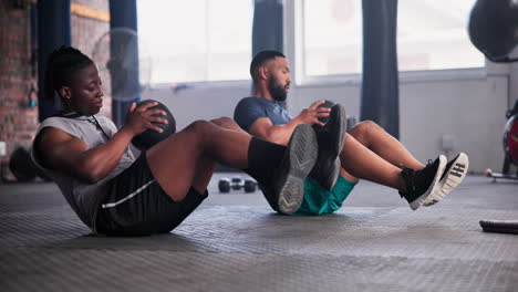 two men doing medicine ball exercises