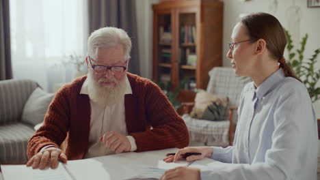 elderly couple having home consultation with financial advisor