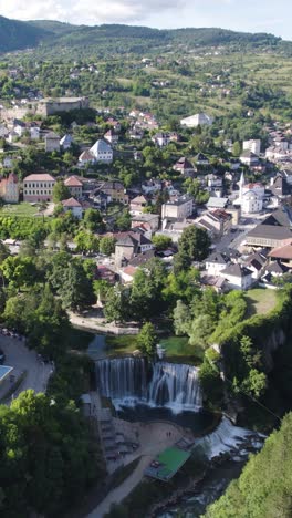 pliva waterfall by the town of jajce in bosnia and herzegovina. aerial vertical