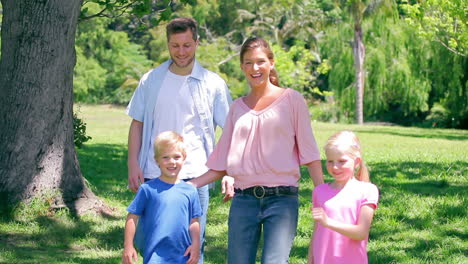 Boy-kicking-a-ball-as-he-runs-with-his-family