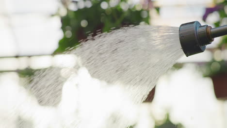 macro shot of water dripping from hose nozzle