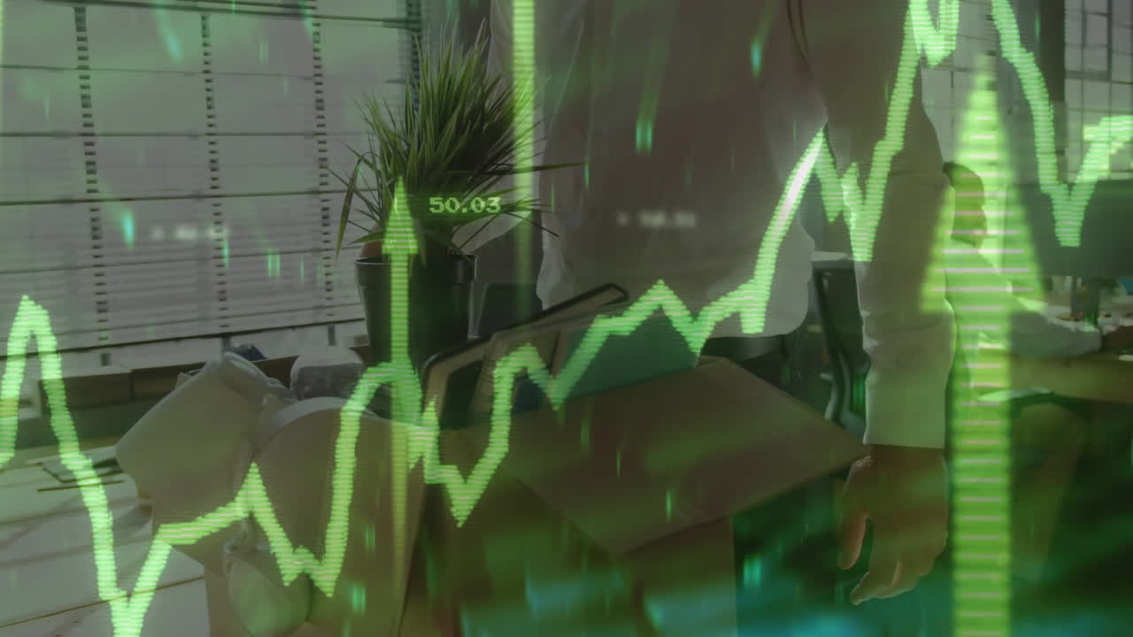 Green financial graph animation over person carrying box in office setting