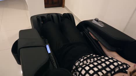 woman lying and relaxing on the massage chair