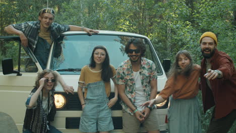 joyous friends posing by van for group photo