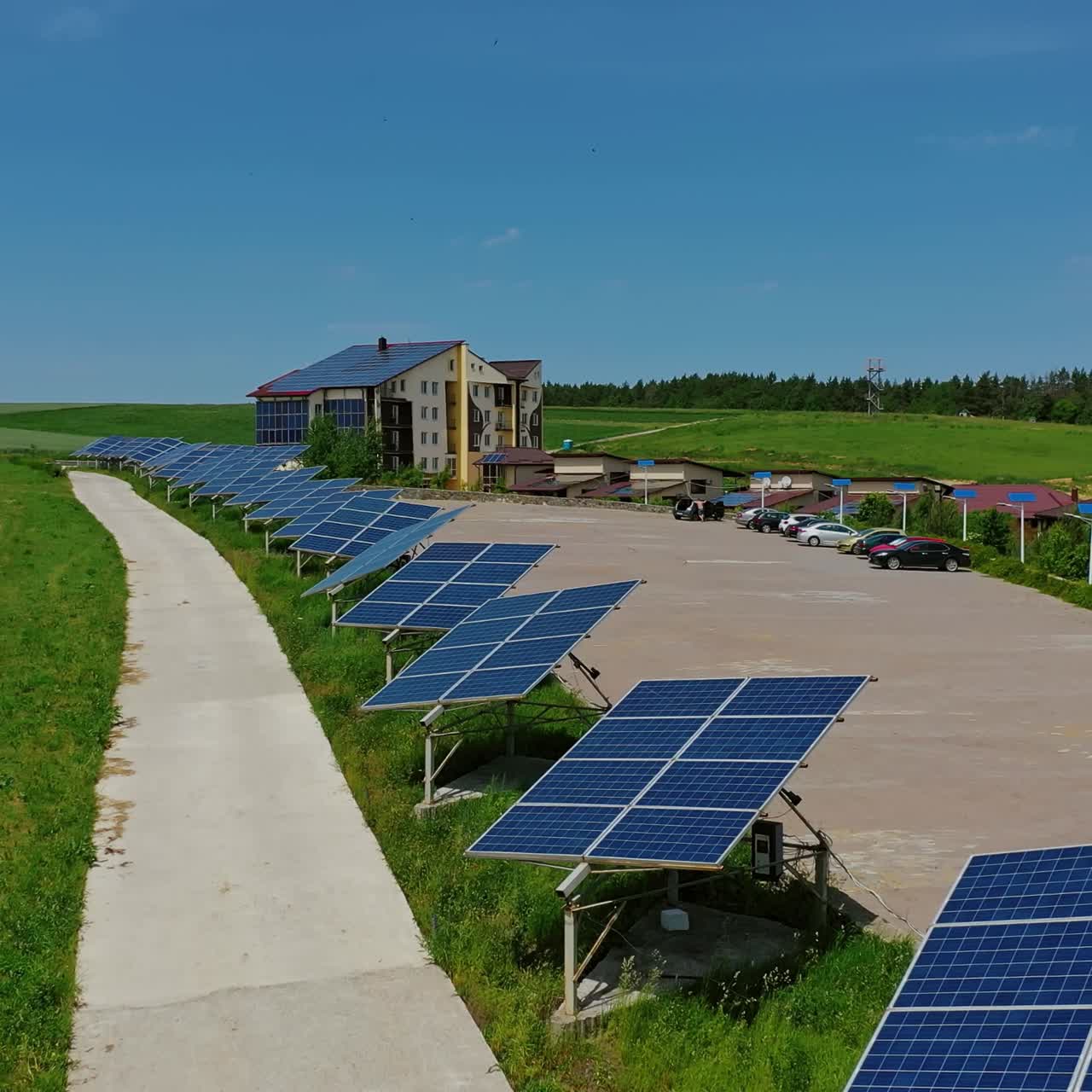 Futuristic solar panels among nature. Modern complex with sunny batteries to receive clean energy from the sun. Renewable source of energy.