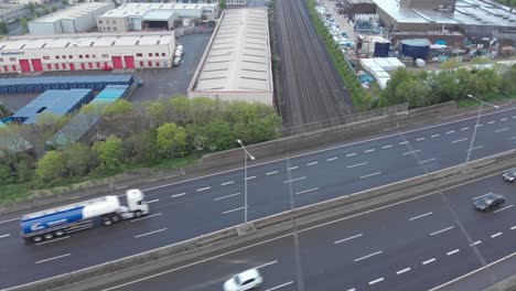 m50 motorway and train tracks in dublin, ireland with clondalkin business park in the background - aerial shot
