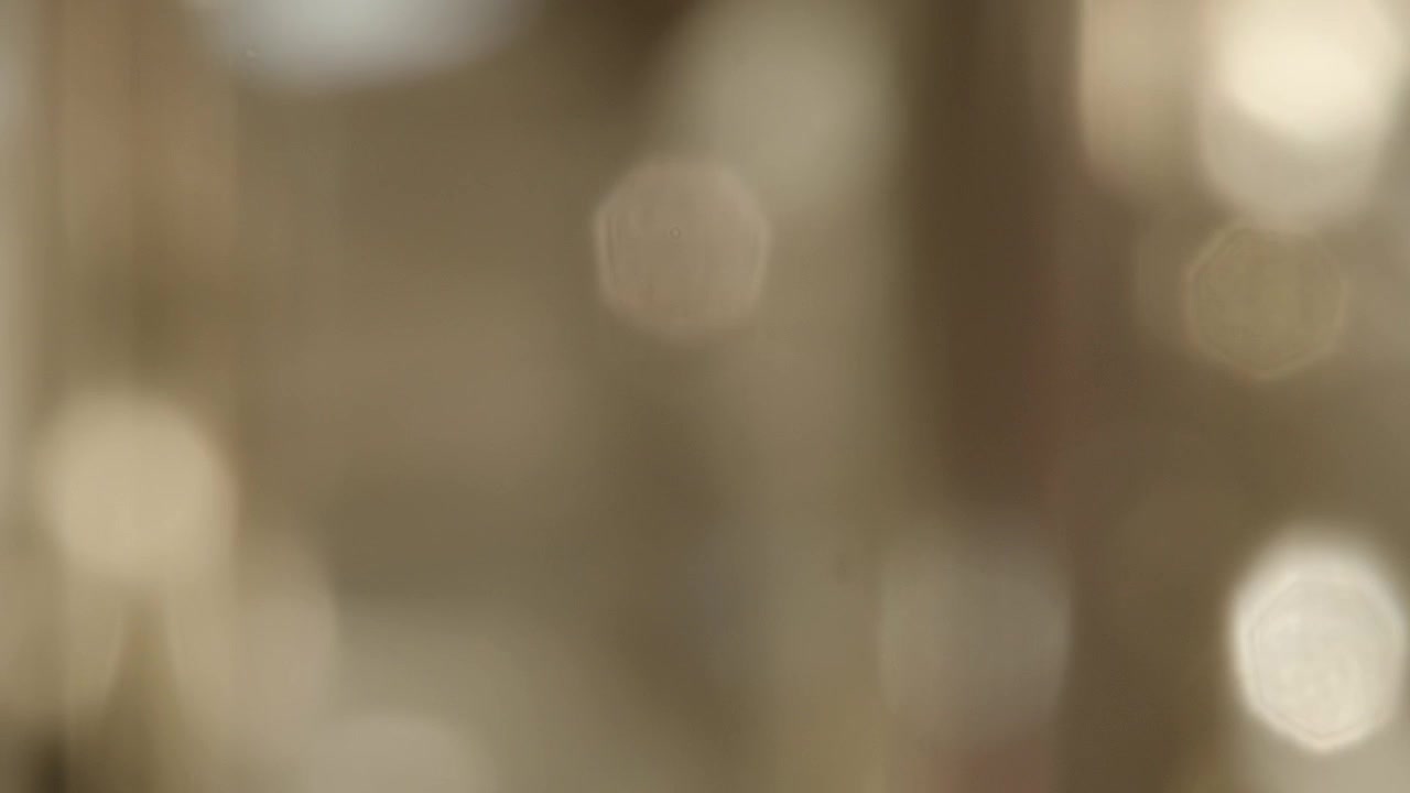 Sfondo astratto in lento movimento di particelle bokeh dorate