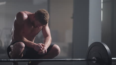 Beautiful-Athletic-man-Wipes-Sweat-from-His-Forehead-with-a-Hand-Looks-into-Camera.-He's-Tired-after-Intensive-Cross-Fitness-Exercise