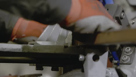 Cutting-steel-bars,-Hands-placing-the-bar-in-the-clamps-of-an-electric-metal-saw