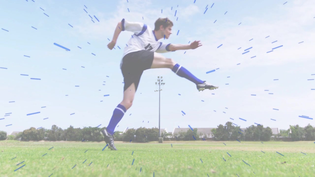 Male soccer player running from left, planting foot, kicking ball forward, creating blue streaks