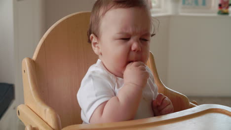 Baby-Boy-Being-Fed-By-Mother-In-High-Chair