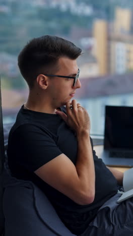 Young Man Working at a Window