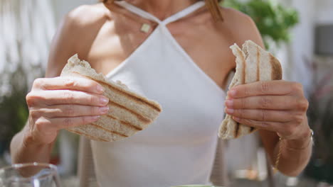 woman hands holding pita dinning lebanese restaurant closeup. lady eating bread