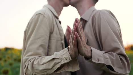 men holding hands outdoors