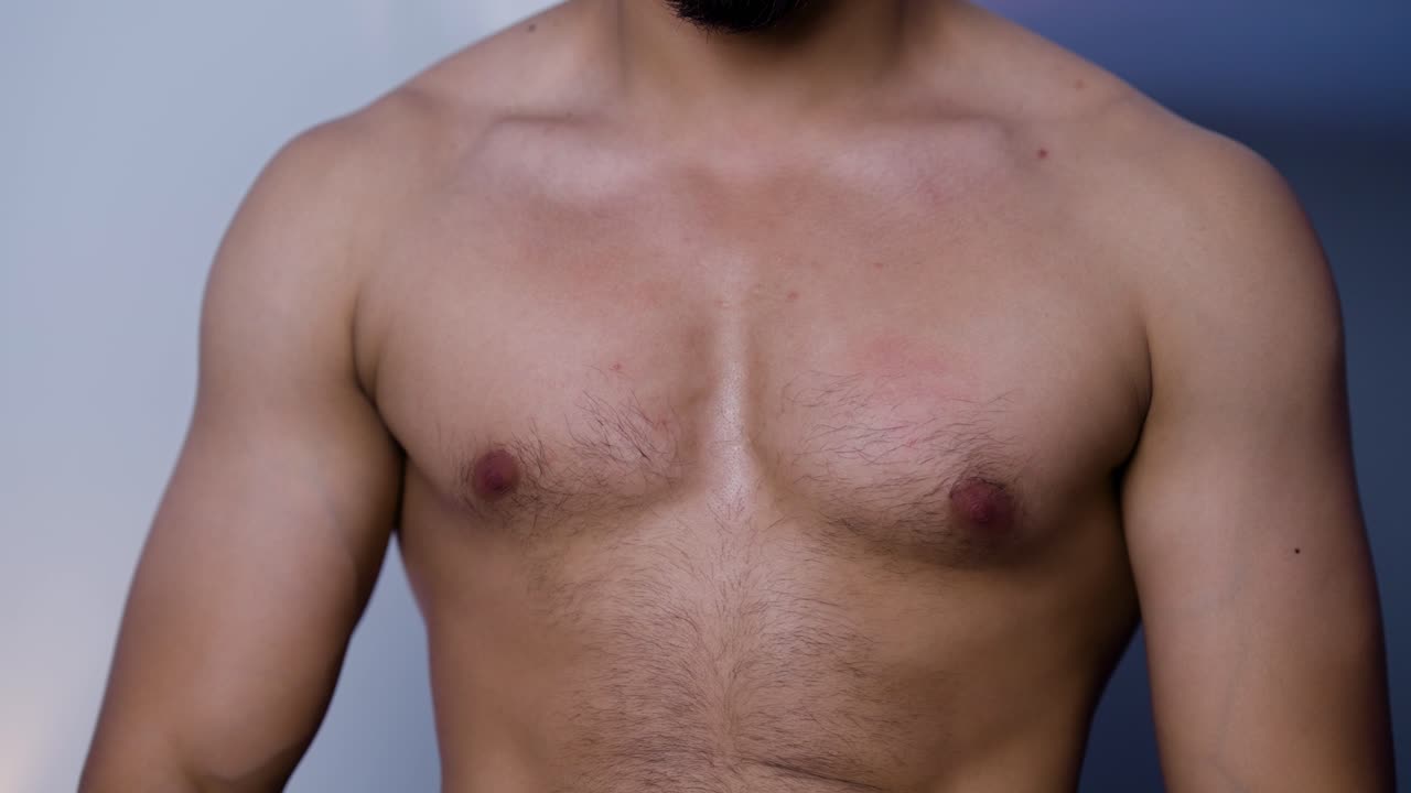 Strong Young Man Flexing Chest Muscles – Fitness, Bodybuilding, and Athletic Workout Video