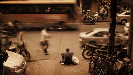 a lively intersection filled with cars, motorcycles, and bicycles as pedestrians navigate the area. the energy reflects a typical day in a vibrant urban environment.