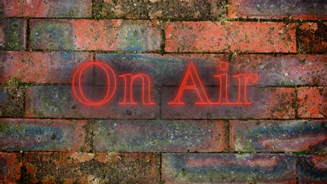 on air red neon graphic on brick wall