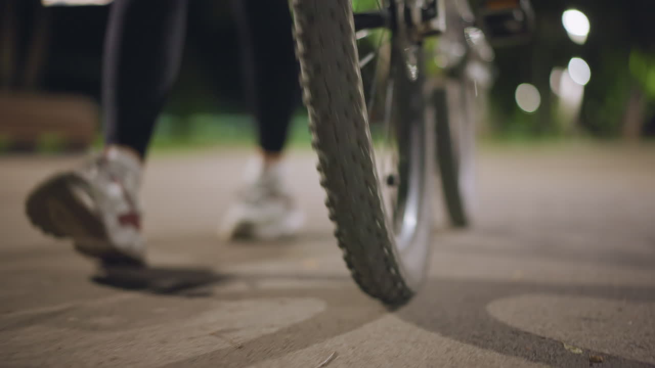 Closeup Of Tire And Foot In Motion, Detailed Image Of Moving Tire And Foot Under Lights, Detailed Closeup Photograph Showcasing Tire And Foot In Dynamic Motion Illuminated By Park Lighting