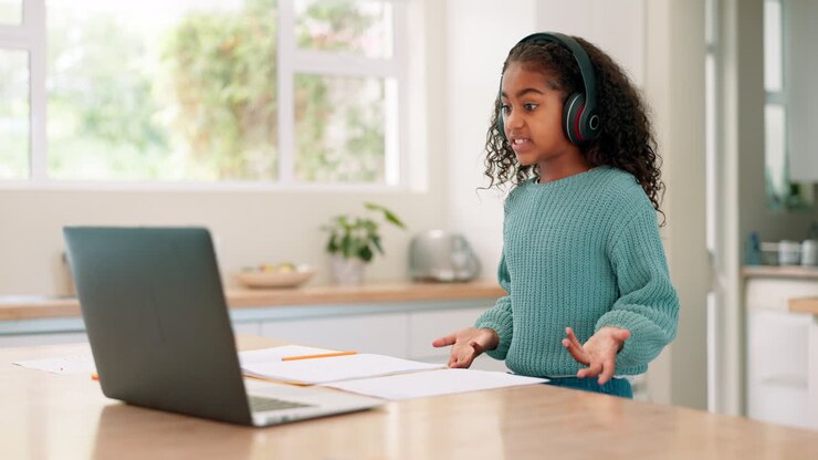 Laptop, headset and e learning with a child