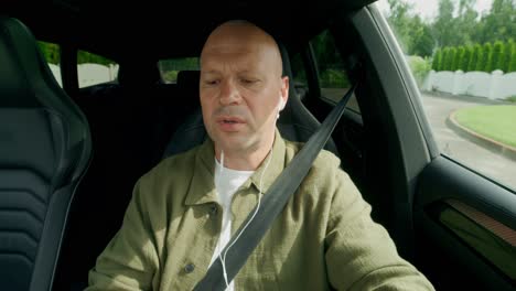 man driving a car and talking