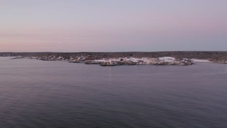 Portland-Head-Light-blinking-during-winter-sunrise-AERIAL-PUSH-IN