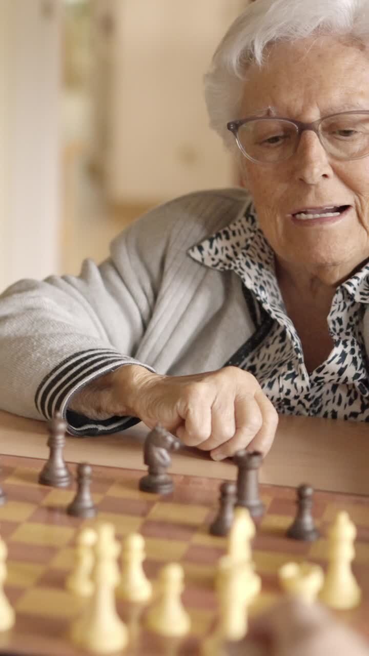 Senior friends playing chess in a nursing home