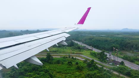 airplane descends over lush krabi landscape