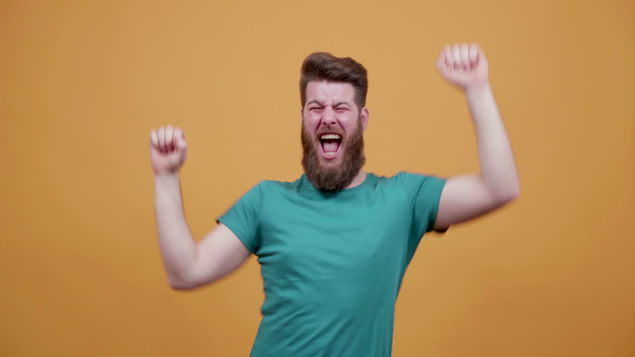 Bearded Man Celebrates Success with Joyful Exuberance