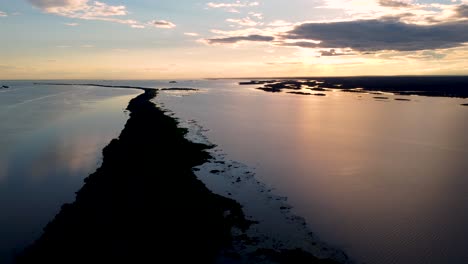 flying over an island in the middle of the parana river at sunset - brazil