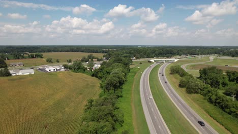 An-aerial-view-of-two-curved-roads-beside-a-field-with-a-line-of-trees-between-them