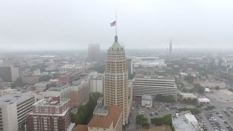 Historic-Emily-Morgan-Hotel-in-downtown-San-Antonio,-Texas-on-a-foggy-day-with-drone-video-circling