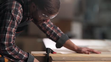 closeup portrait of carpenter clamping carpentry board