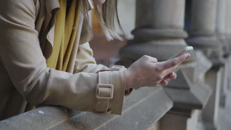 Student-hands-using-smartphone-in-hallway.-Businesswoman-working-on-cellphone