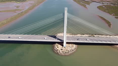 Rising-aerial-view-of-Portimao-Bridge-over-Arade-River-in-Portugal