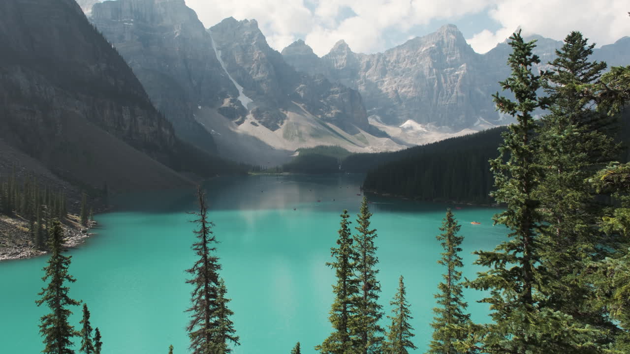 Valley of the Ten Peaks vista, framed by towering evergreen trees