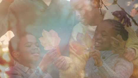 Animation-of-happy-african-american-family-outdoors-over-leaves