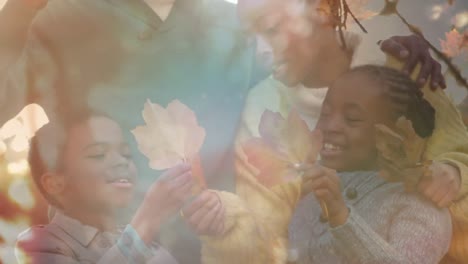 animation of happy african american family outdoors over leaves