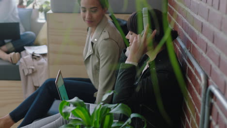 young business women relaxing on lunch break wearing headphones listening to music friends enjoying sharing together in modern startup office