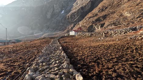 walking over a rocky path towards the monastery of langtang village in langtang valley, nepal